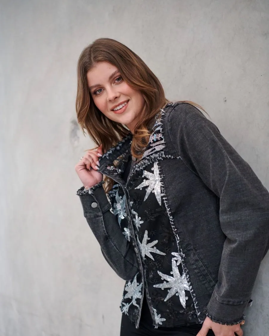 Model in a black jacket with silver star detail