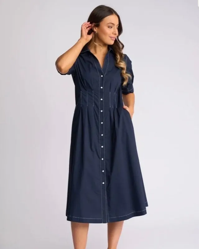 Model in a navy shirt dress