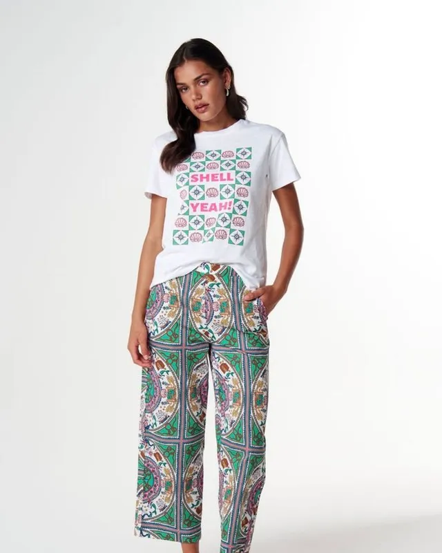 Model in a graphic tee and printed wide-leg pants