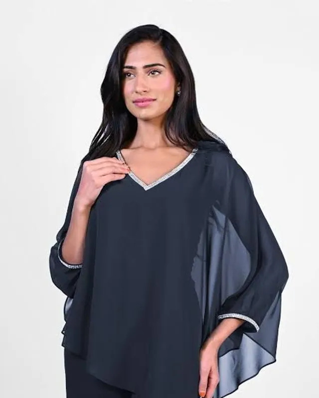 Model in a navy chiffon top with a beaded neckline