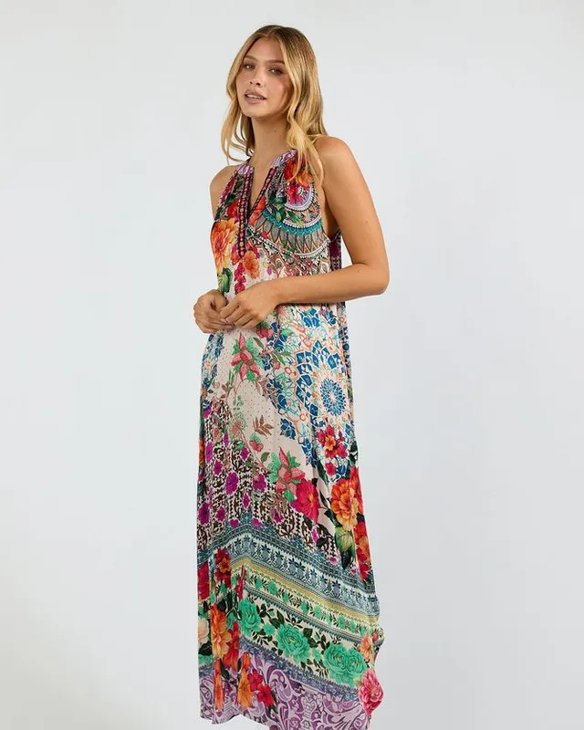Model in a long printed halter maxi dress