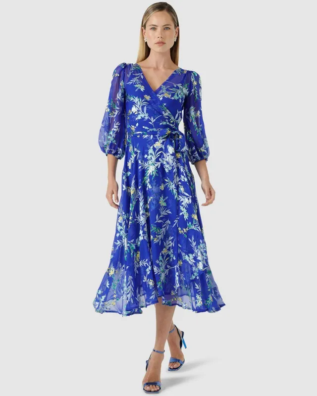 Model in a blue floral wrap dress
